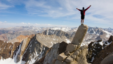 man-standing-on-edge-of-cliff